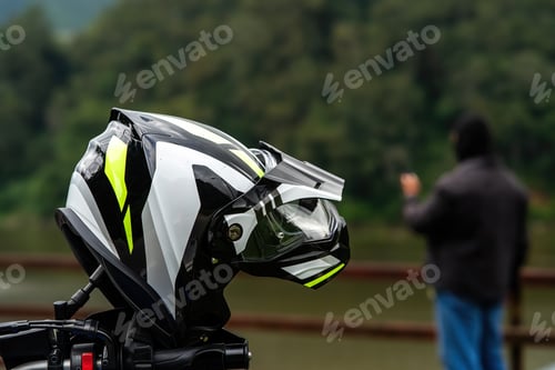 Preview: Sport helmet closeup with a man in black shirt and blue jeans in a blurry background.