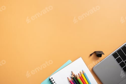 Preview: Stationary and laptop with graduated cap on coloured background flat lay. Online learning concept