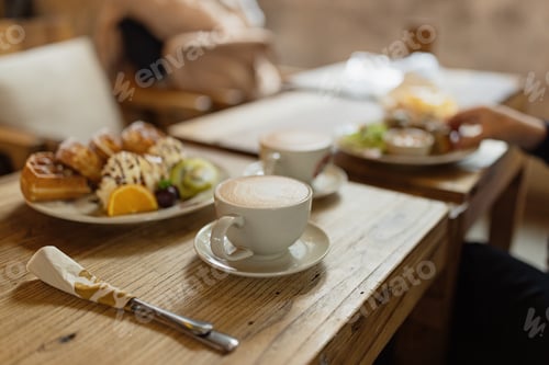 Preview: Whole wheat waffles, ice cream, kiwi and coffee on brown wooden rustic table.