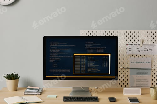 Preview: Front view computer with code lines on screen in minimal home office setup