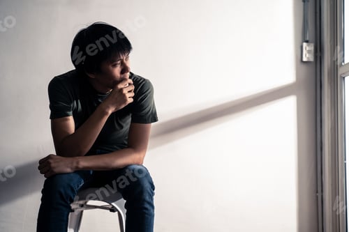 Preview: Asian male unemployed worker sitting on chair feeling stress that have no job due to covid-19