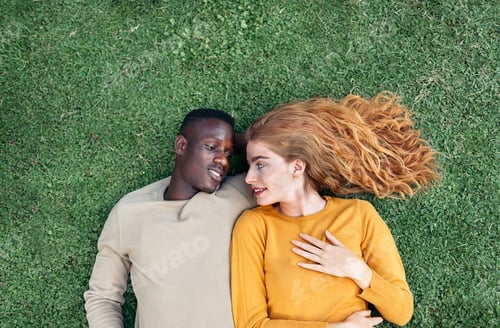 Preview: Multiethnic Couple Cuddling in the Grass