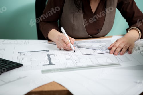Preview: Close up of architect hands working on blueprints