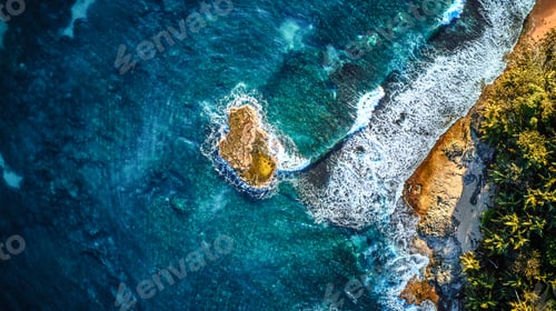Preview: Scenic aerial shot of a tiny rock island surrounded by waves of the crystal clear ocean