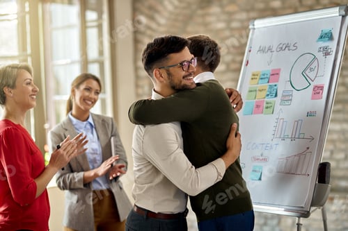 Preview: Happy businessman congratulating to each other on successful presentation in the office.
