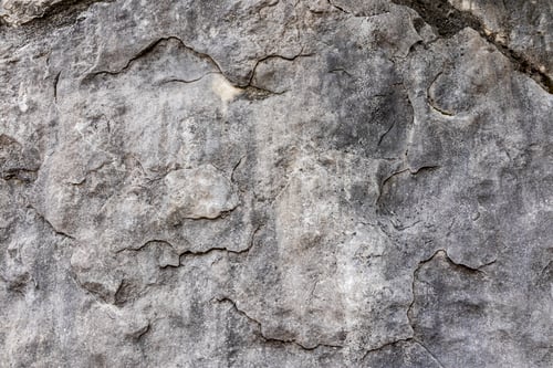 Preview: gray stone wall background. Rocky surface with natural texture. Relief texture of natural rock