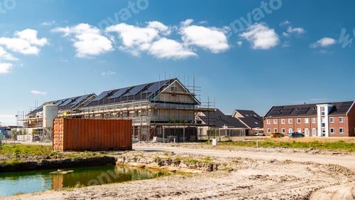 Preview: Newly build houses with solar panels attached on the roof against a sunny sky