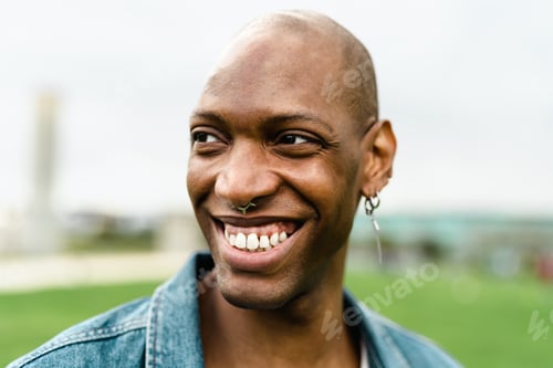 Preview: Happy African gay man posing and smiling in front of camera