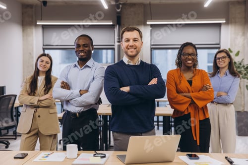 Preview: Multi ethnic business team smiling with arms crossed, showing confidence and teamwork