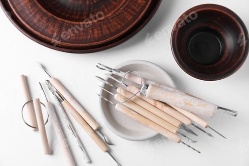 Preview: Set of different clay crafting tools on white table