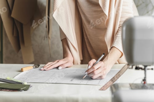 Preview: Female fashion designer creating sewing pattern in the sewing atelier. Small business owner