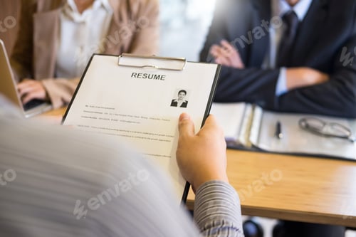 Preview: young man explaining about his profile to business managers sitting in job Interview