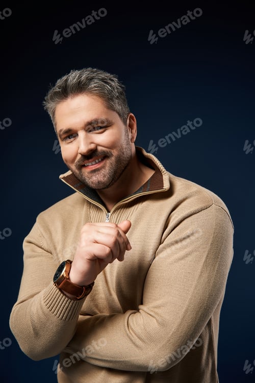 Preview: Handsome man showcasing a trendy outfit in a studio setting during a fashion shoot