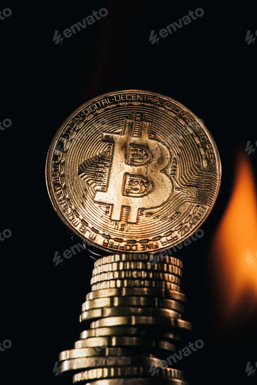 Preview: Close up view of golden bitcoins and fire isolated on black