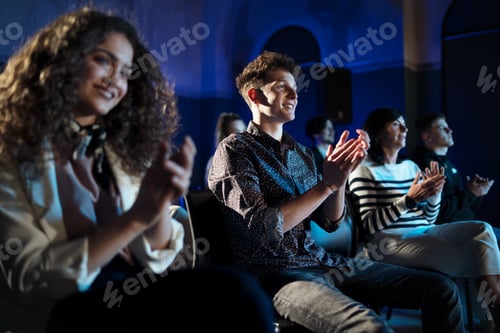 Preview: Group of people clapping while listening to presentation at conference