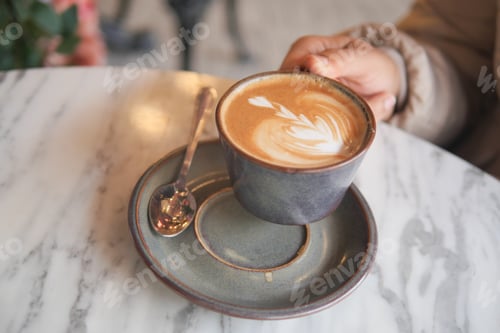 Preview: An Artistic Coffee Cup is elegantly placed on a Marble Table, accompanied by a Spoon