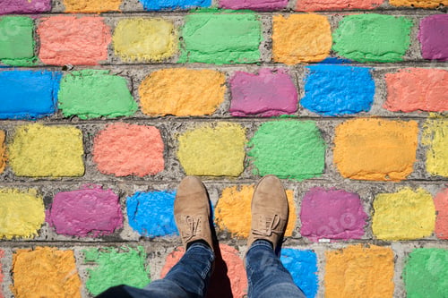 Preview: Argentina, Buenos Aires, La Boca, point of view shot of man standing on colorful pavement