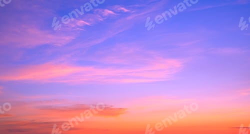 Preview: Evening sky background with colorful orange and pink sunlight clouds on beautiful blue sunset sky