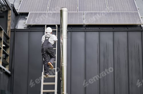 Preview: Technician climbing up the ladder while installing photovoltaic solar panels on roof of house.