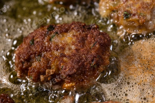 Preview: Frying large homemade Romanian meatballs parjoale or chiftele