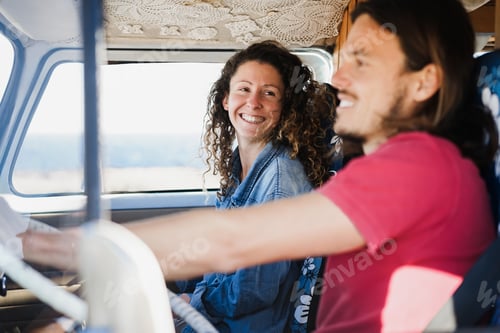 Preview: Happy couple inside minivan doing a road trip during summer vacation - Focus on girl face