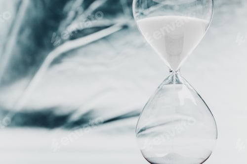 Preview: Time flows gracefully through a clear hourglass on a light surface reflecting soft shadows