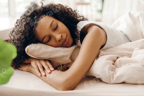 Preview: Peaceful African American woman sleeping in cozy bed at home