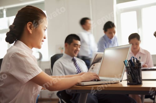 Preview: Woman working on her laptop in the office
