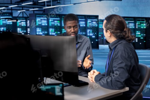 Preview: System administrators reconfiguring server room equipment