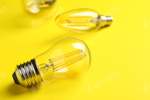 Preview: Vintage lamp bulb on yellow background. Space for text