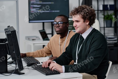 Preview: IT specialists writing codes for new software