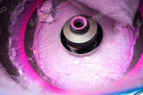 Preview: Machine to make cotton candy by turning and toasting the pink sugar.