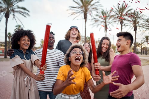 Preview: An international group of young people celebrate with confetti outside