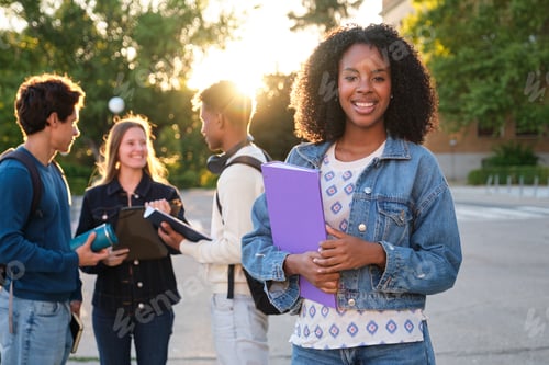 Preview: Diverse students smiling while learning on university campus