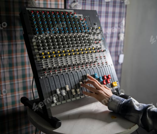 Preview: a Sound Engineer Adjusting Faders on a Mixing Console During Studio Session