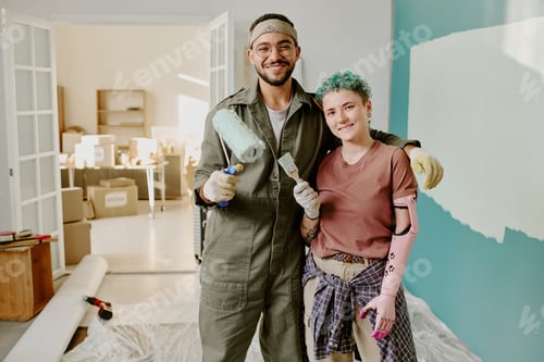 Preview: Young Multiethnic Couple Painting Wall and Renovating New Home Together