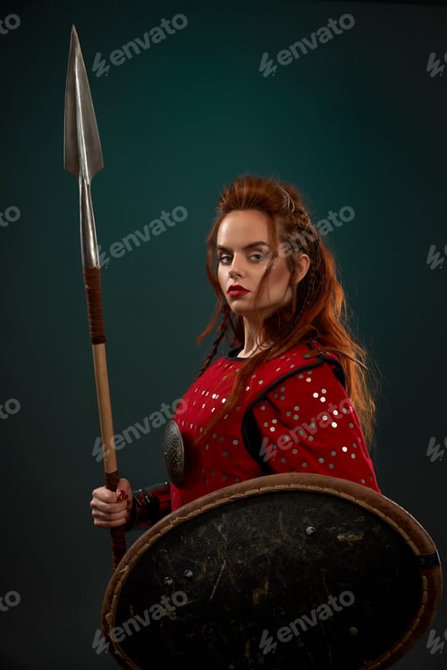 Preview: Powerful female fighter in armor keeping spear and shield