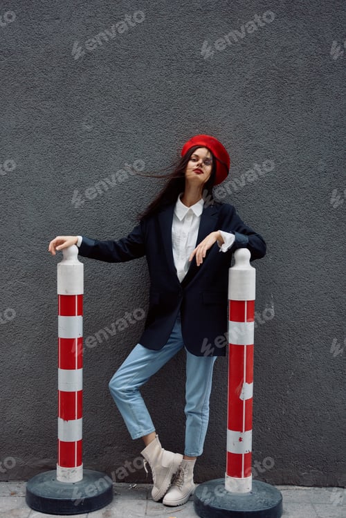 Preview: Fashion woman standing on the street in front of the city and road works tourist in stylish clothes