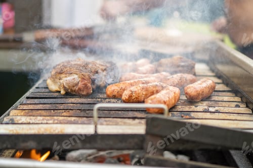 Preview: Meat cooking in an outdoor smoky barbecue