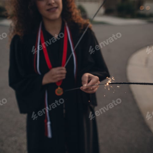 Preview: Hppy graduate holding sparklers