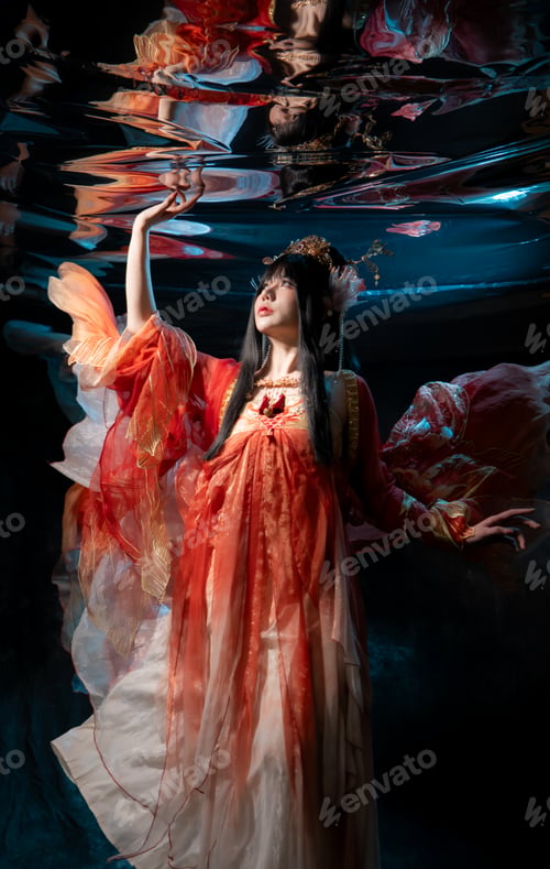Preview: Asian woman in traditional red costume with golden details