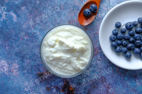 Preview: close up of fresh yogurt with blue berry in a bowl