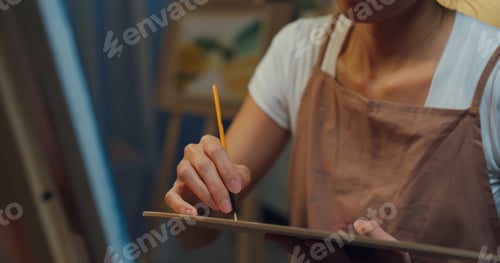 Preview: Lady wear apron holding palette use brush painting on canvas create artwork workshop.
