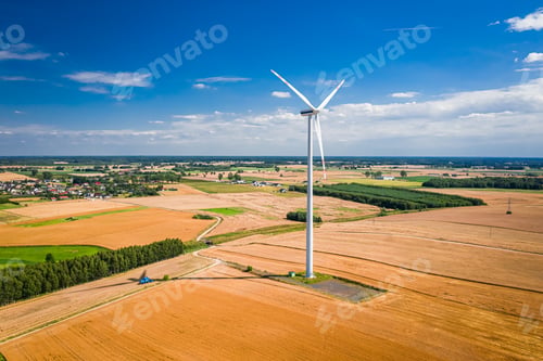 Preview: Harvest on golden field and wind turbine. Agriculture in Poland.