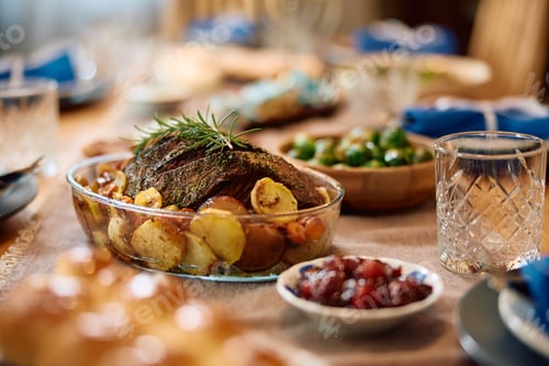 Preview: Jewish beef brisket on dining table prepared for a meal on Hanukkah.
