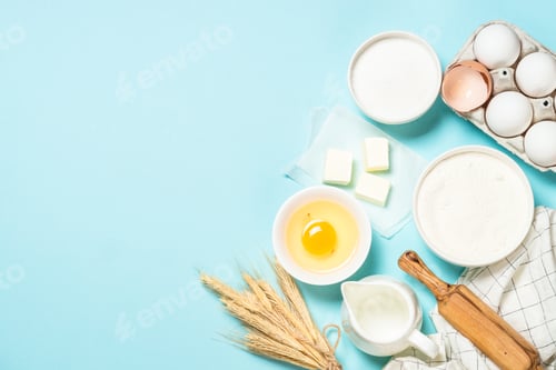 Preview: Baking ingredients at blue table top view