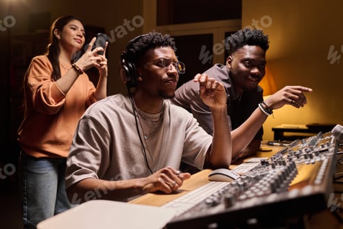 Preview: Young Multiethnic Musicians Collaborating in Recording Studio during Production