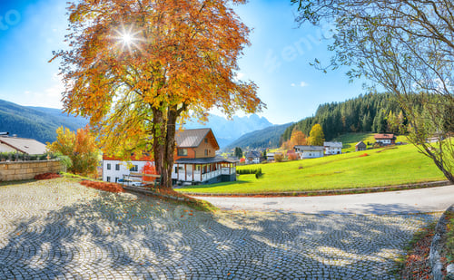 Preview: Alpine green fields and traditional wooden houses view of the Gosau village at autumn sunny day.