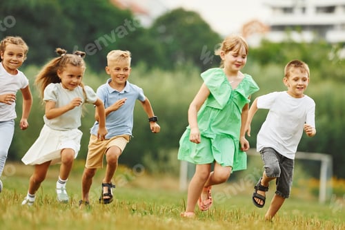 Preview: Running, active time spending. Kids are having fun on the field at daytime together