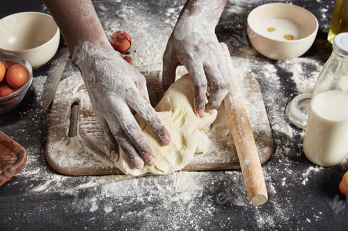 Preview: Indoor shot of unrecognizable male has dirty hands makes shapes from pastry, bakes tasty rolls with